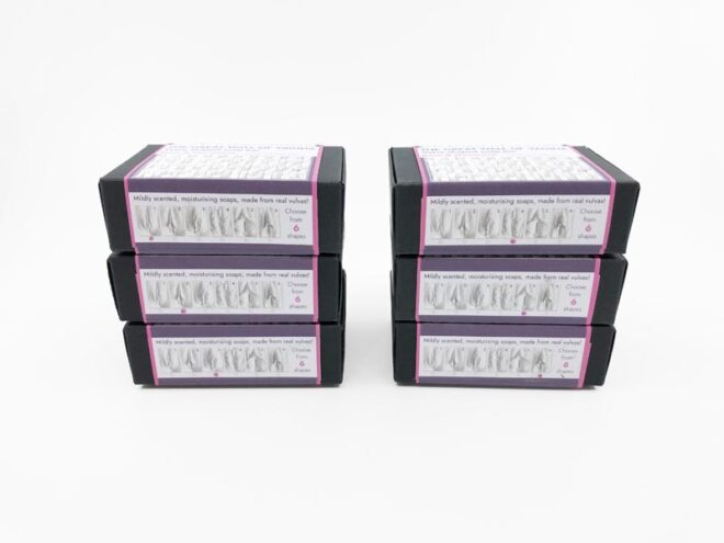 six vulva shaped natural soap bars in eco-friendly packaging