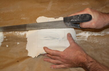 sawing down a plaster vulva cast
