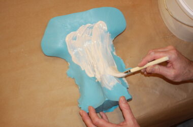 painting plaster onto a vulva mould