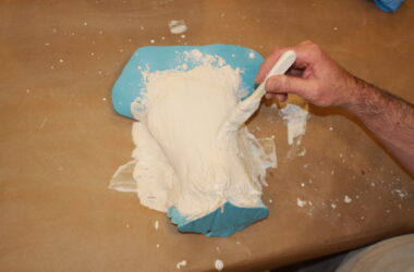 painting plaster onto a vulva mould
