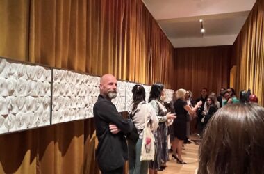 Jamie McCartney poses with visitors to The Great Wall of Vagina at the Amor Veneris launch