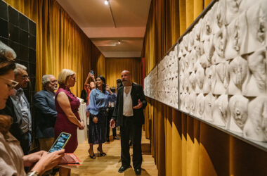 Jamie McCartney talks with visitors to The Great Wall of Vagina at the Amor Veneris launch