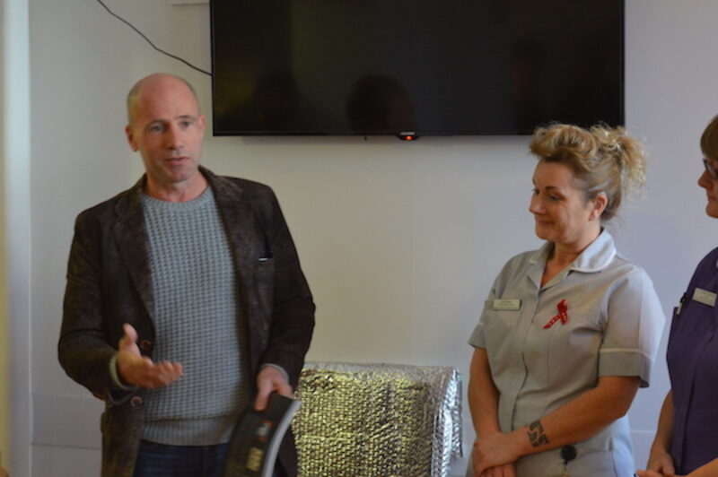 Jamie McCartney presents a signed Great Wall of Vagina book at the Brighton SHAC sexual health clinic