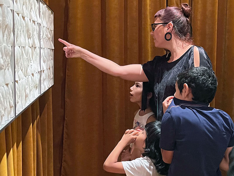 a woman and her children looking at The Great Wall of Vagina